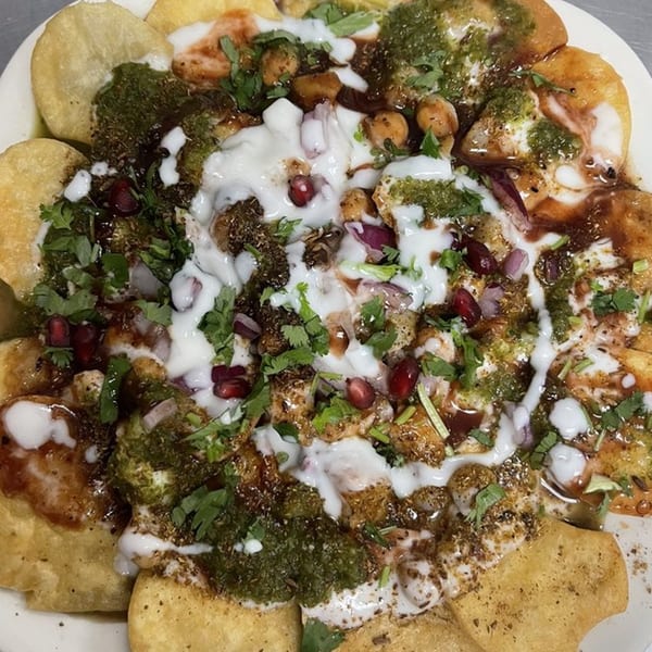Heart of India's Indian chaat, a savory snack with crispy flatbread, sauces, and fresh toppings.